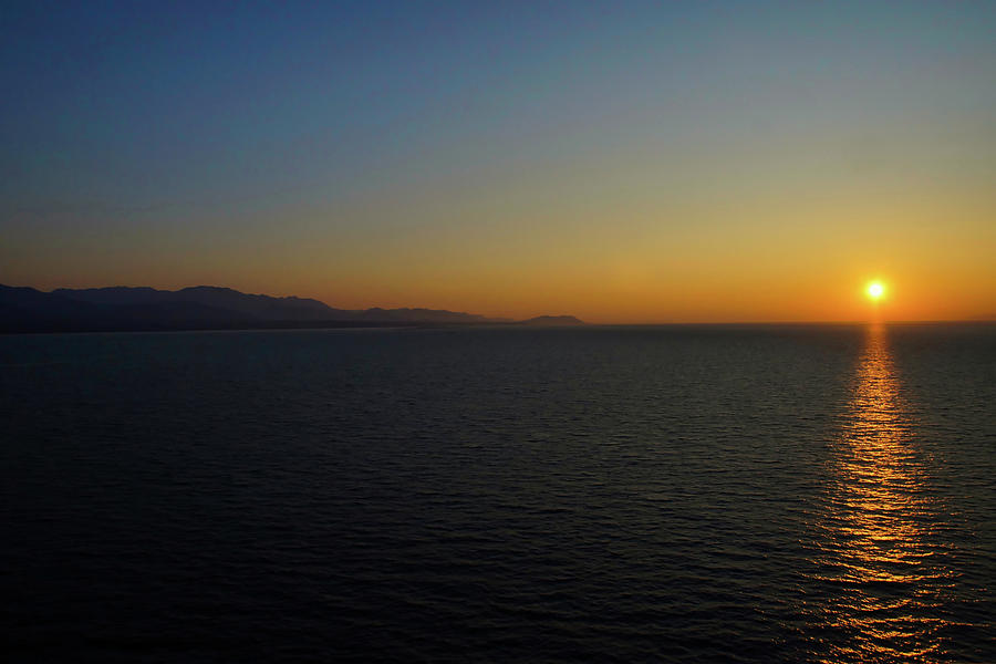 Sunset at sea Photograph by Ernest Echols