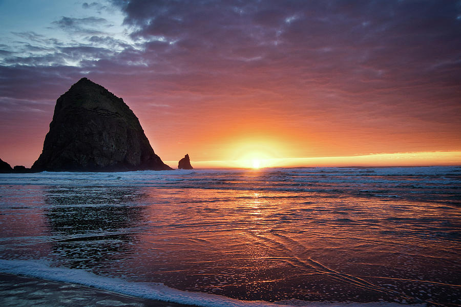 Sunset at the Rock - Cannon Beach Photograph by Jeanette Mahoney