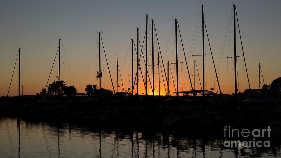 Sunset in a marina Photograph by Agnes Caruso