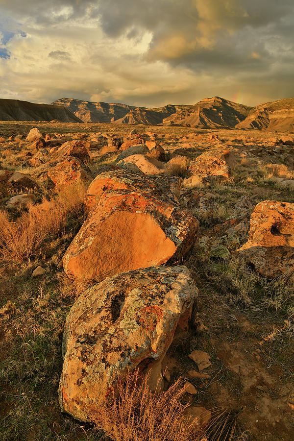Sunset on Lichen Covered Boulders and Book Cliffs Photograph by Ray Mathis