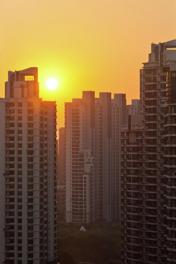 Sunset Over Apartment Buildings In Photograph by Yves Andre