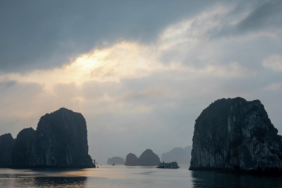 Sunset over cruise ship in karst rock foramtions in Ha Long Bay  Photograph by Karen Foley