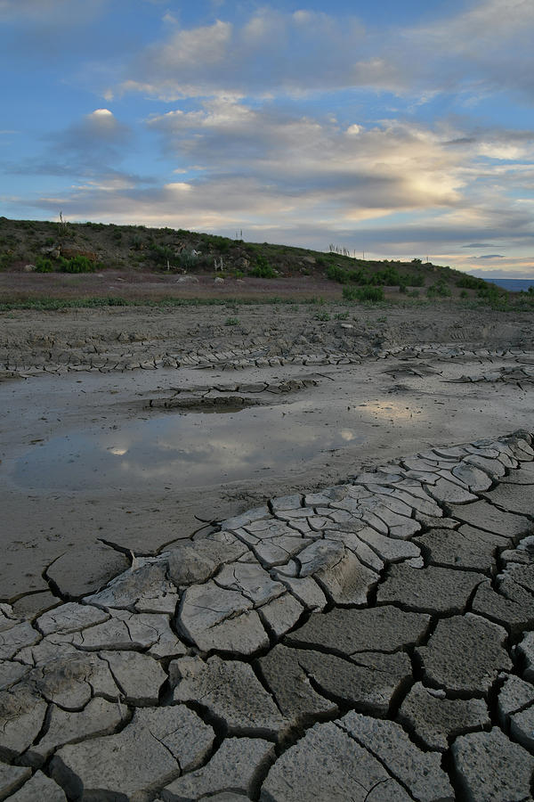 Sunset over Mud Cracks along 25 Road Photograph by Ray Mathis