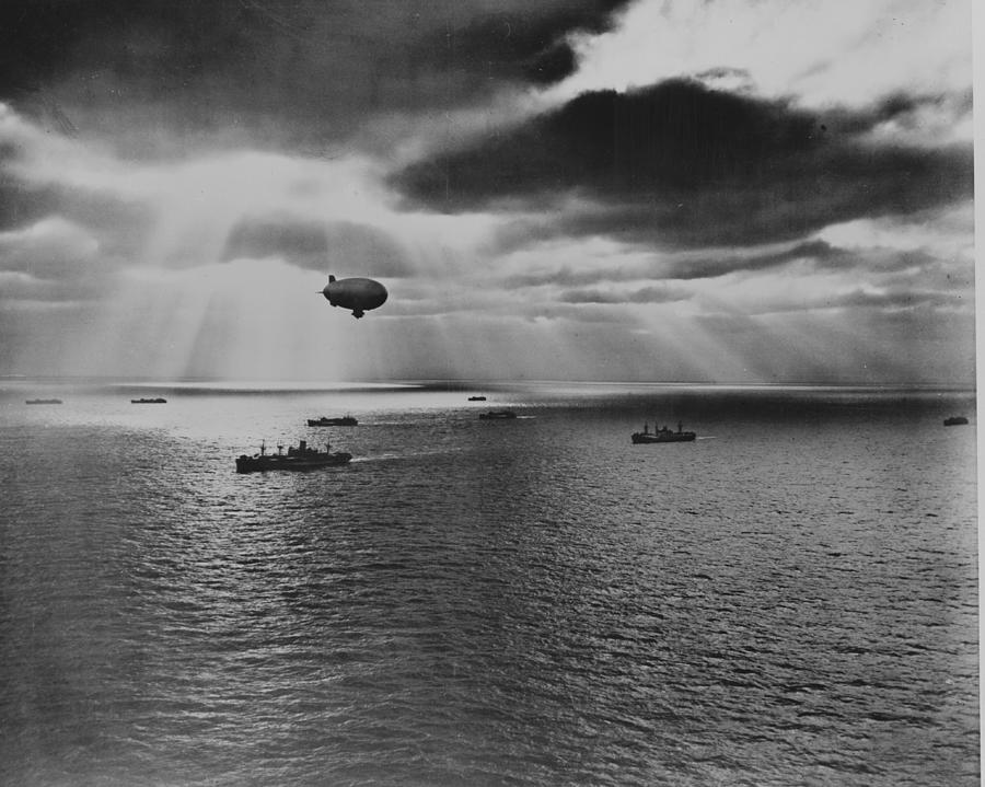 Sunset over the Atlantic finds another United Nations convoy moving peacefully towards it destination. A U.S. Navy blimp, hovering watchfully overhead, is on the lookout for any sign of enemy submarines Painting by 