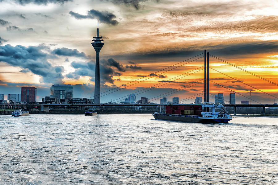  Sunset over the Rhine river with bridge and Dusseldorf city sca Photograph by Marek Poplawski