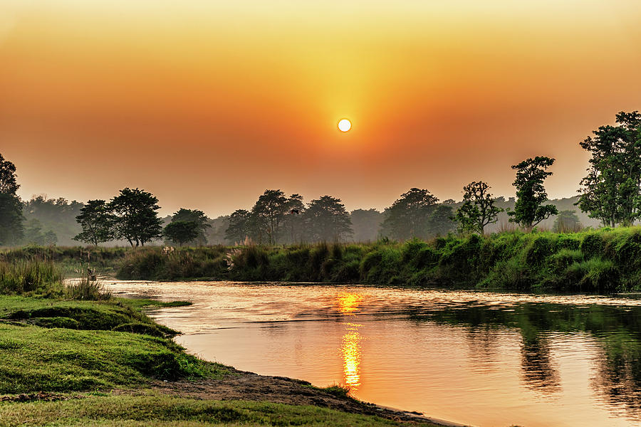 Sunset over the river in Chitwan National Park, Nepal Photograph by Marek Poplawski