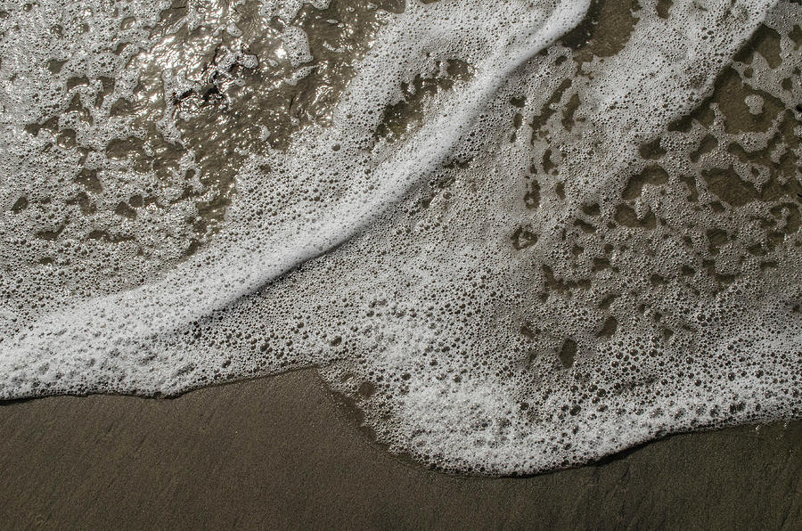 Surf Foam On The Sand Photograph by Alan Goldberg