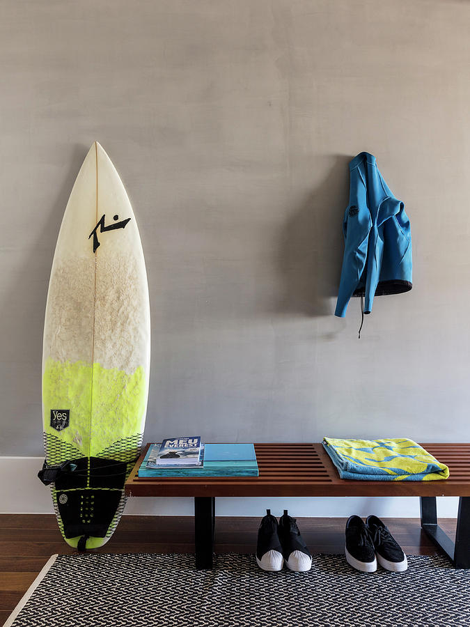 Surfboard Next To Wooden Bench With Pairs Of Shoes Below Photograph by Nicolas Bouriette