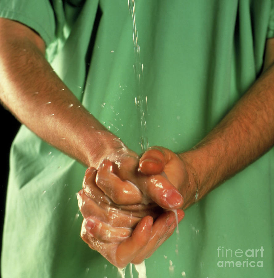 Surgeon Scrubbing His Hands Before An Operation Photograph by Cc Studio/science Photo Library