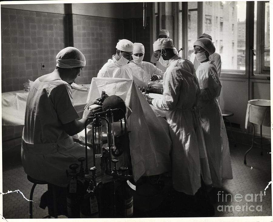 Surgeons Working On Patient Photograph by Bettmann