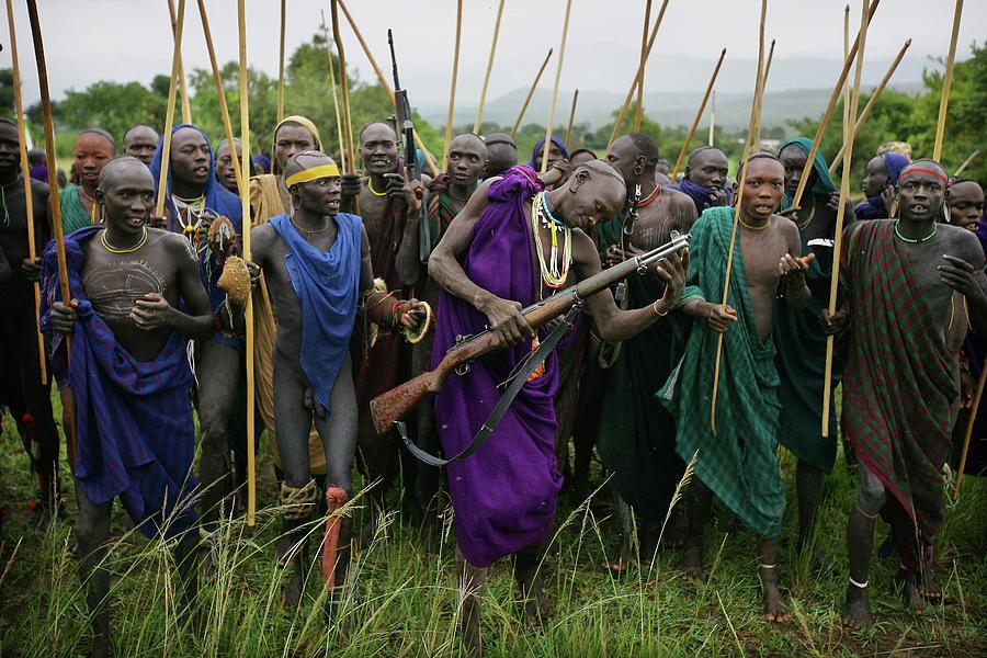 Suri Tribal Warriors, Sticks & Guns At Photograph by Timothy Allen