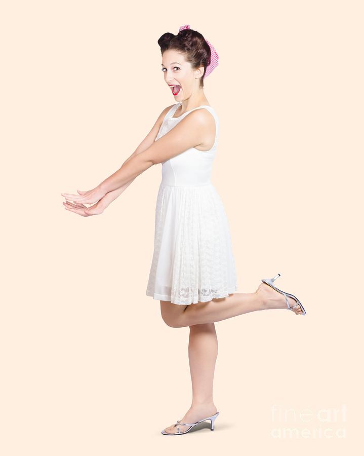 Surprised housewife kicking up leg in white dress Photograph by Jorgo Photography