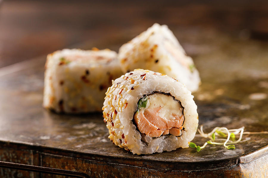 Sushi Roll With Salmon, Cream Cheese And Green Onion Covered With Sesame Seeds Photograph by Yumpic Studio