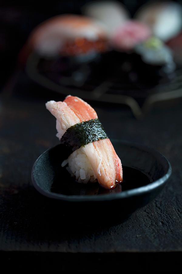 Sushi With Crab Being Dipped In Soy Sauce Photograph by Martina Schindler