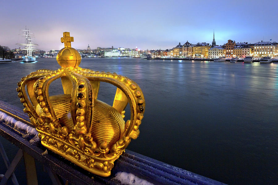 Sweden, Stockholm, Scandinavia, Gamla Stan, Gamla Stan And Af Chapman Sailing Ship From Skeppsholmen Bridge With Gilded Crown In The Foreground Digital Art by Pietro Canali