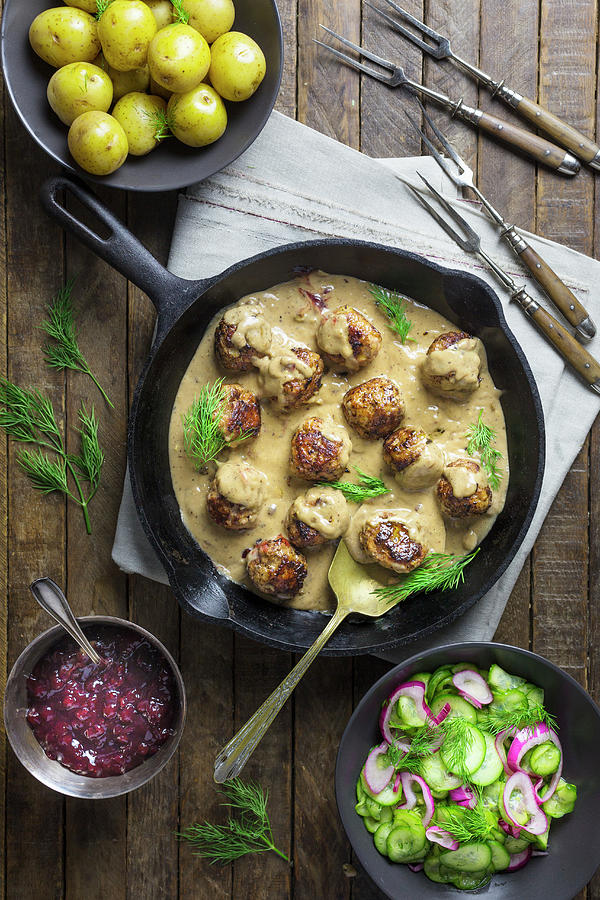 Swedish Meatballs In A Creamy Sauce With Cucumber Salad And New Potatoes Photograph by Emily Clifton