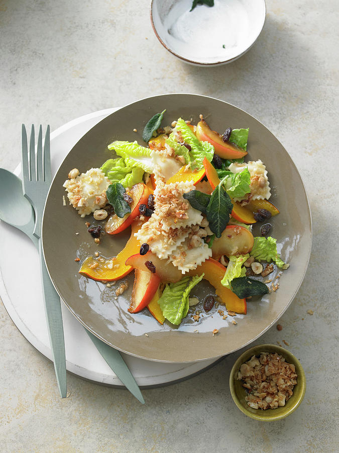 Sweet-and-sour Pumpkin And Apple Salad With Sage And Raisins On Fried Ravioli On Crispy Breadcrumbs Photograph by Jan-peter Westermann