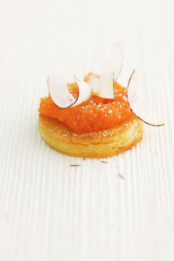 Sweet Pastry Topped With Carrot & Passion Fruit Spread And Coconut Shavings Photograph by Michael Wissing