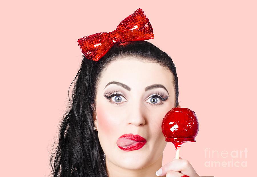 Sweet pin-up girl eating a candy toffee apple Photograph by Jorgo Photography
