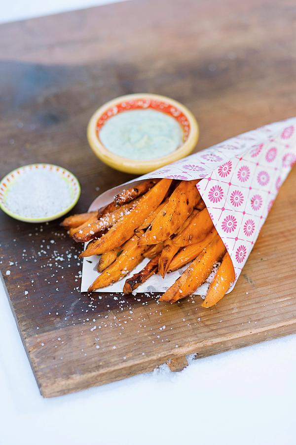 Sweet Potato Chips In A Paper Bag With Herb Sauce Photograph by Jalag / Wolfgang Schardt