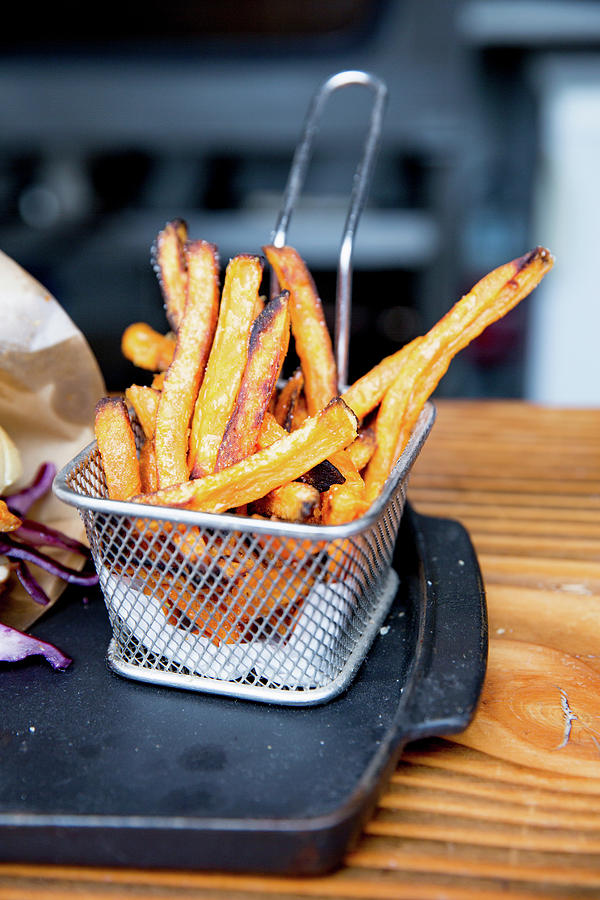 Sweet Potato Fries In A Wire Basket Photograph by Claudia Timmann