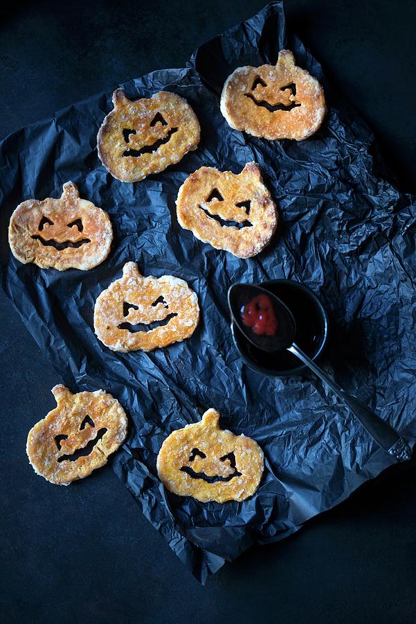 Sweet Potato Pumpkins With Black And Red Ketchup For Halloween Photograph by Kati Neudert