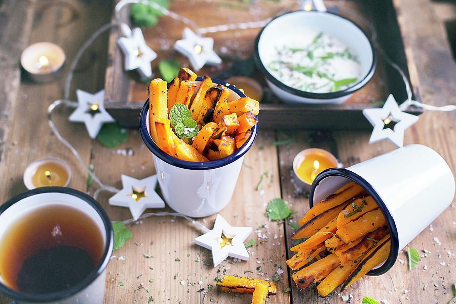 Sweet Potatoes Fries With Sae Salt Flakes And Fresh Mint Leaves; Served On A Wooden Table Photograph by Natalia Mantur