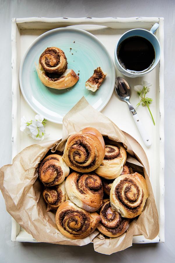 Sweet Yeast Swirls With A Brown Sugar, Cinnamon And Pecan Nut Filling On A Tray With Coffee Photograph by Magdalena Hendey