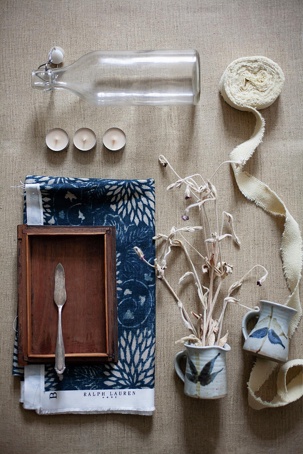 Swing-top Bottle, Tealights, Ribbon, Dried Flowers In Small Jug And Fish Knife In Wooden Box Photograph by Alicja Koll