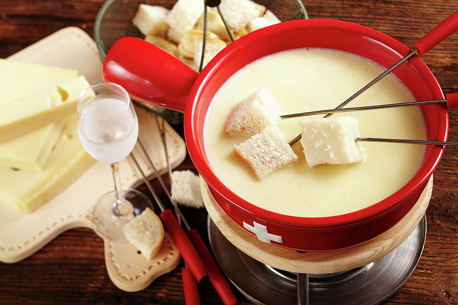 Swiss Cheese Fondue In A Rechaud With A Glass Of Kirschwasser And Bread Photograph by Teubner Foodfoto