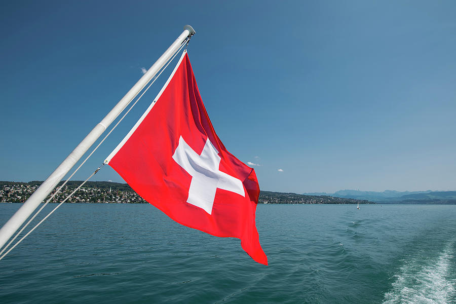 Swiss Flag At The Back Of A Boat On The Zurich Lake Photograph by Cavan ...