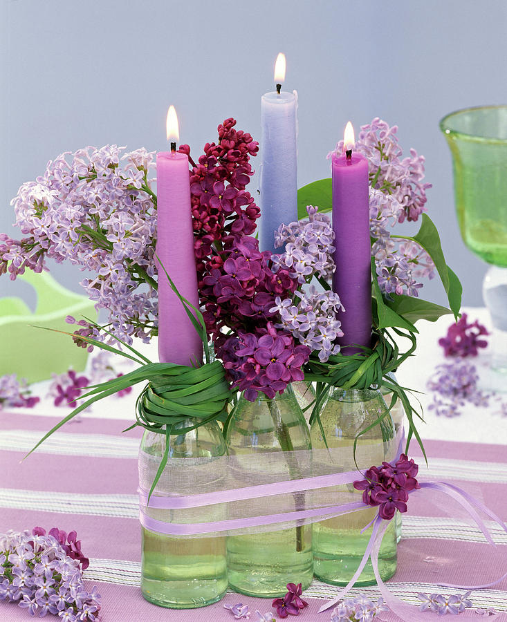 Syringa In Small Bottles With Wreaths Of Grass As A Candle Holder Photograph by Friedrich Strauss