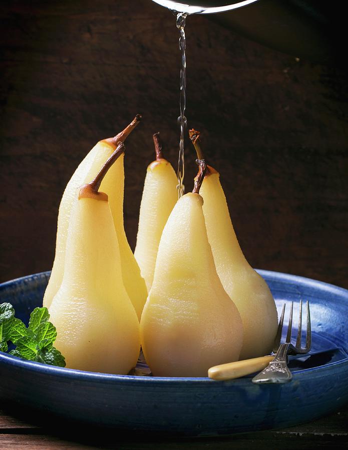 Syrup Being Poured Over Pears Poached In White Wine Photograph by Natasha Breen