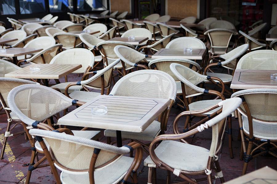Table And Chairs At An Outdoor Cafe In The South Of France Photograph by Bruce James