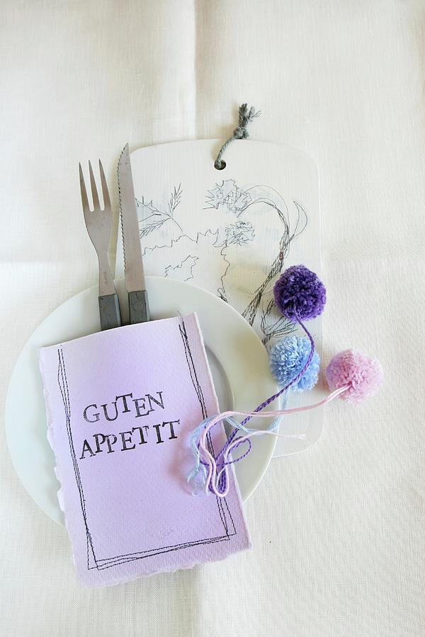 Table Decoration: Cutlery In Hand-made, Stitched Paper Bag With Stencilled Letters And Pompoms Photograph by Regina Hippel