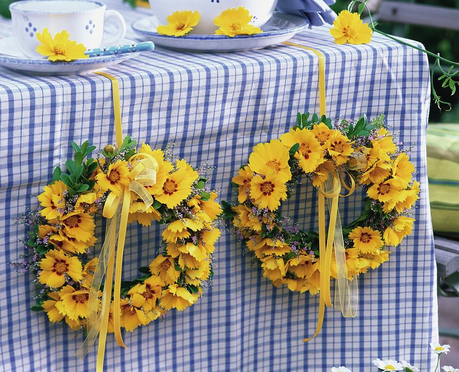 Table Decoration Of Wreaths Of Coreopsis And Sea Lavender Photograph by Friedrich Strauss