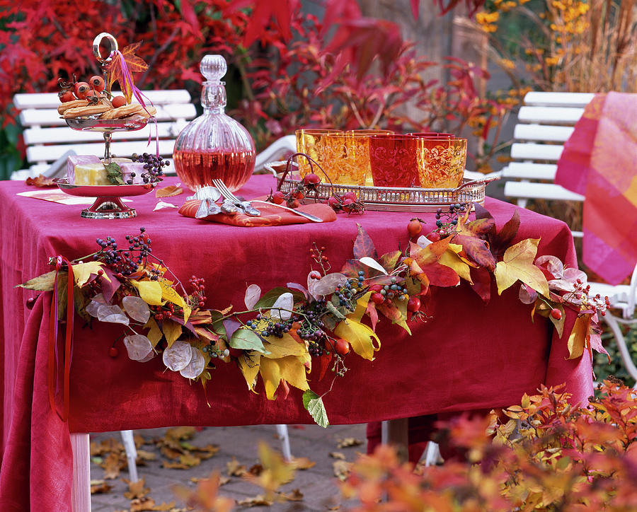 Table Decoration With Garland Of Autumn Liquidambar Leaves Photograph by Friedrich Strauss