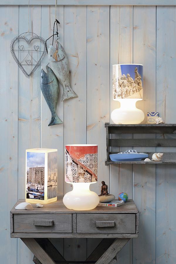 Table Lamps With Lampshades Covered In Holiday Photos Against Board Wall Photograph by Thordis Rggeberg