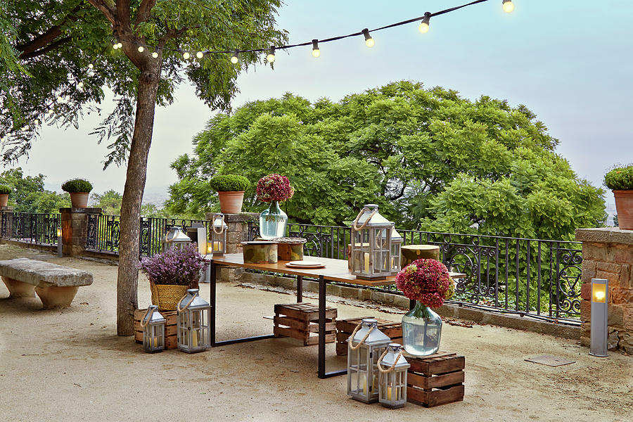 Table, Lanterns, Hydrangeas In Demijohns And Wooden Crates Photograph by Miriam Rapado