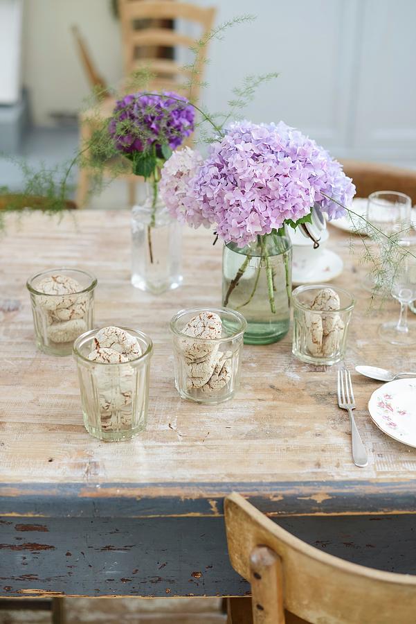 Table Set With Biscuits In Glasses And Vases Of Hydrangeas Photograph by Irene Berni