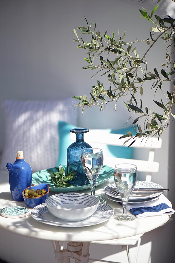 Table Set With Blue And White Crockery On Terrace Photograph by Winfried Heinze