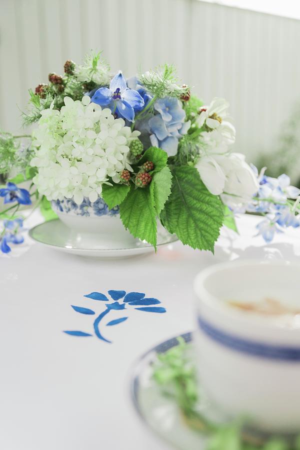 Table Set With Flowers In Blue And White For Afternoon Coffee Photograph by Bildhbsch