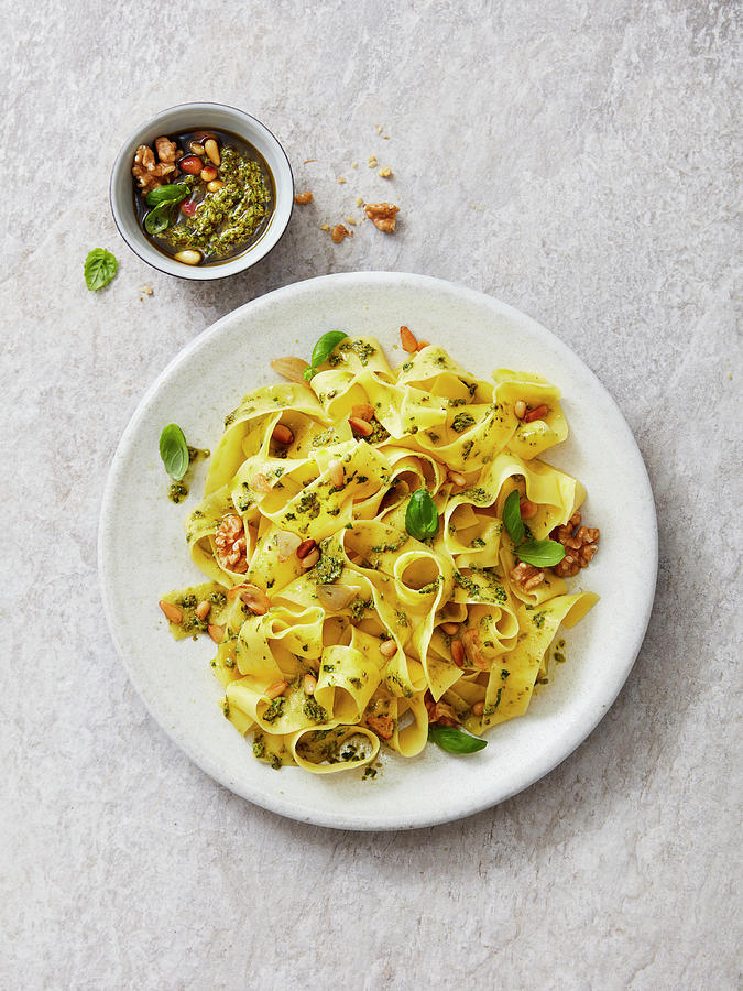 Tagliatelle With Garlic And Basil Pesto, Walnuts, Pine Nuts And Basil Leaves Photograph by Thorsten Kleine Holthaus