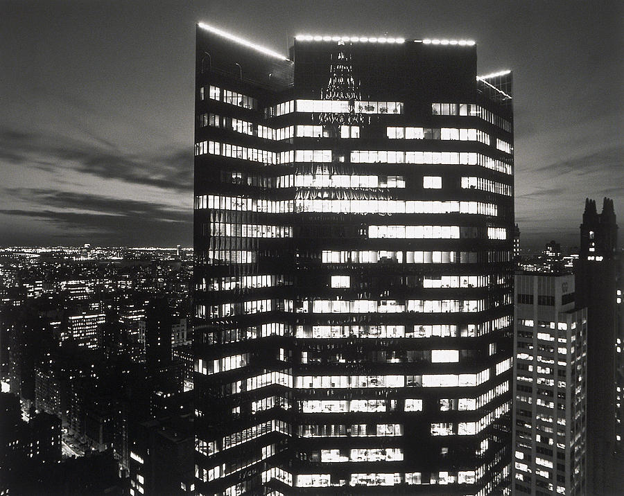 Tall Office Building With Lights On At Photograph by Henri Silberman