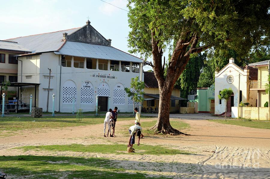 Tamil boys play football in compound of St Marys Cathedral Catholic church Jaffna Sri Lanka Photograph by Imran Ahmed
