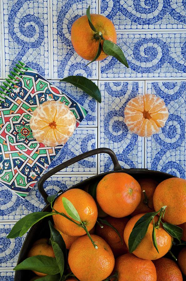 Tangerines With Leaves On Decoratively Patterned Tiles Photograph by Aniko Szabo