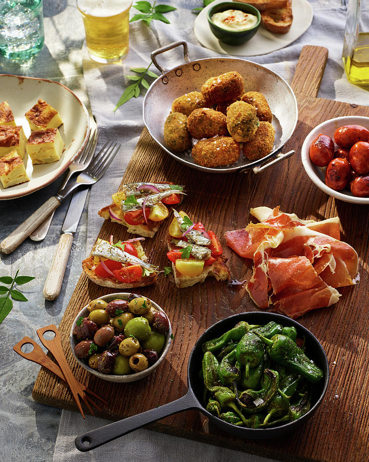 Tapas Selection With Tortilla, Chorizo, Serrano Ham, Croquets, Peppers And Olives Photograph by James Lee