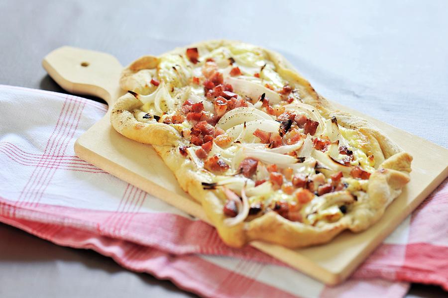 Tarte Flambée Topped With Bacon And Onions Photograph by Ulrike Koeb