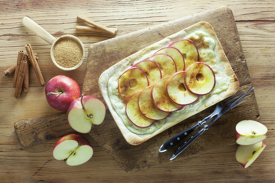 Tarte Flambe With Apples, Sugar And Cinnamon On A Wooden Surface Photograph by Barbara Pheby