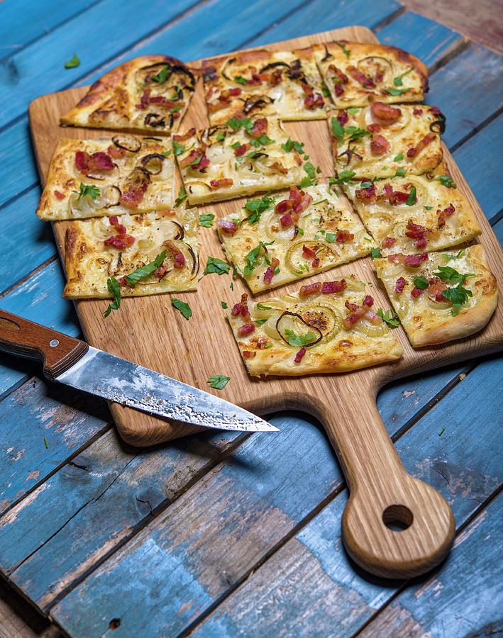 Tarte Flambe With Bacon And Onions On A Chopping Board Photograph by Sebastian Schollmeyer